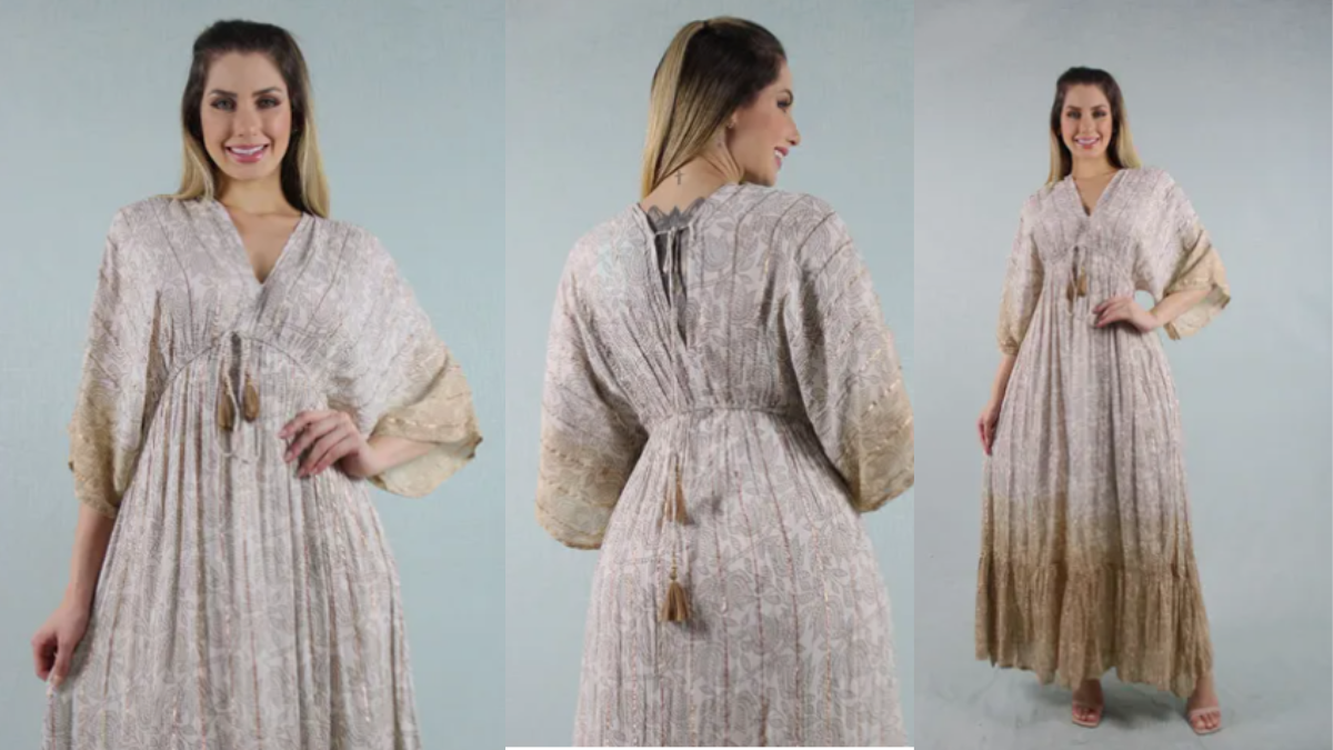 “Vestido longo dourado com manga morcego, estampa sofisticada e bordados delicados, ideal para casamentos, festas e formaturas.”